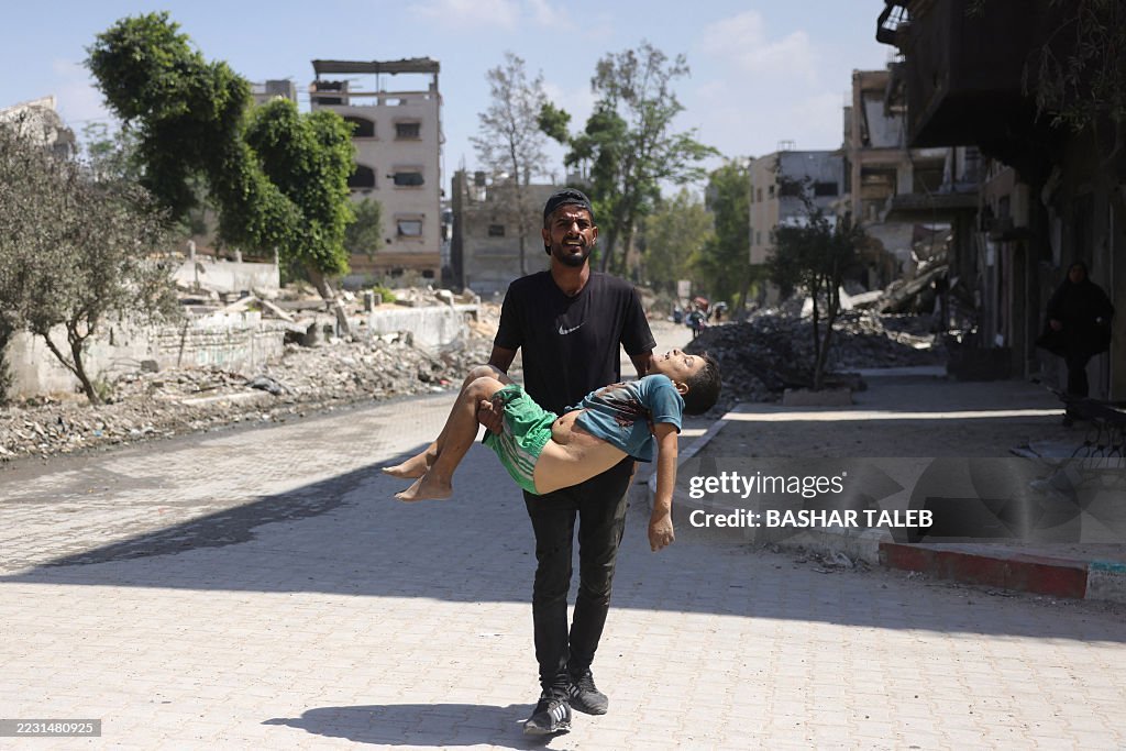 Image for the event titled: Aug 26: man carries killed child during displacement from Jabalia al-Nazla