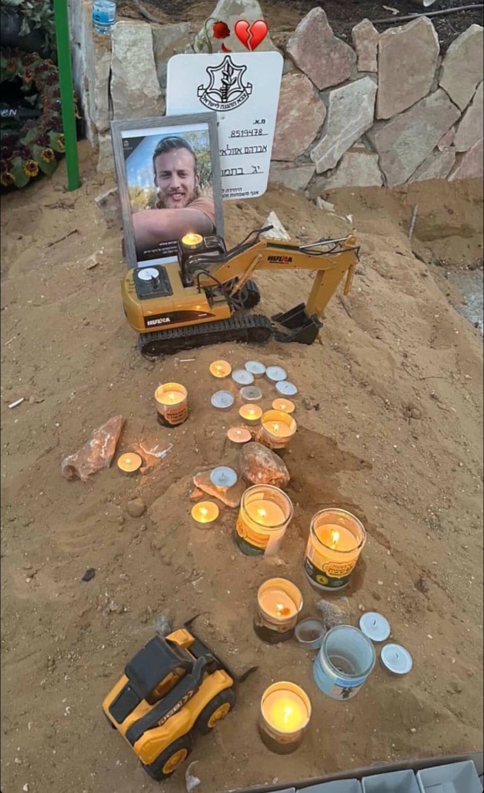 Image for the event titled: Friends of Avraham Azulai put a toy excavator and a toy wheel loader on his grave, to commemorate his destruction of homes in Gaza, and his building of homes for Jews-only on Palestinian land in the West Bank