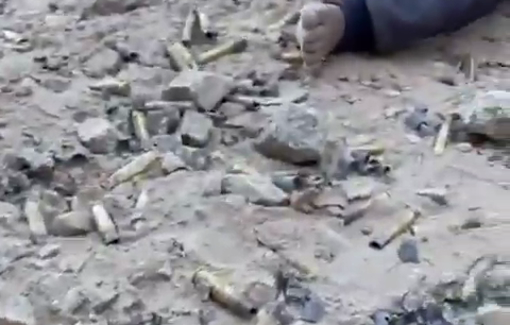 Thumbnail preview image for the video titled: A barefoot Palestinian child plays among the ruins of his home with the bullets the Israeli army fired at his family
