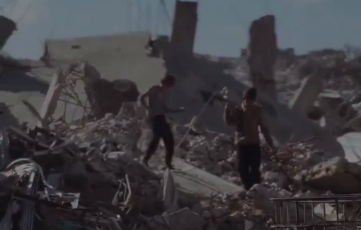 Thumbnail preview image for the video titled: Two children in Gaza dig through the rubble of their destroyed home with a primitive axe, searching for anything usable