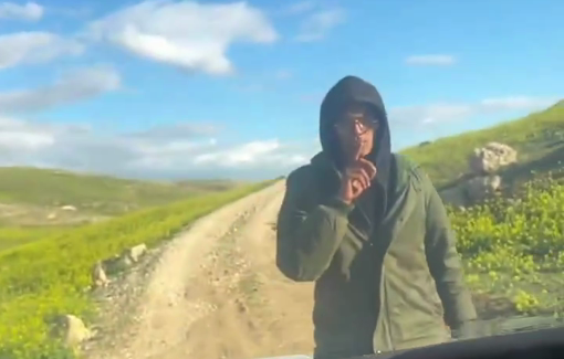 Thumbnail preview image for the video titled: A settler stands in front of a Palestinian civilian’s car to deny access to their home