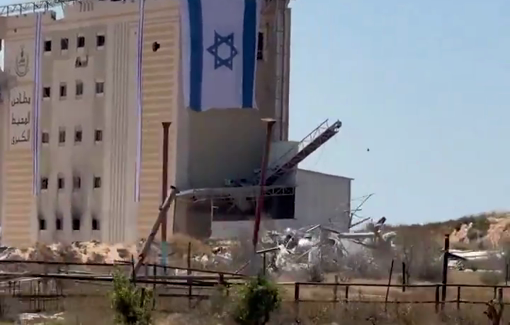 Thumbnail preview image for the video titled: Israel hangs huge flag over the Gaza's largest mill in Gaza to celebrate "Independence day"