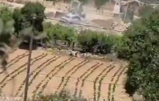 Thumbnail preview image for the video titled: Israeli forces assaulted a Palestinian driver and used a military bulldozer to bury his vehicle in dirt in Beit Ummar