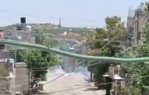 Thumbnail preview image for the video titled: Israeli raid the town. of eit Ummar raid, tear gas and loader destroying Pestinian cars