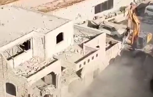 Thumbnail preview image for the video titled: Israeli bulldozers demolish two residential buildings near the apartheid wall in the town of Kafr Aqab