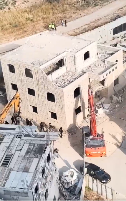 Thumbnail preview image for the video titled: Israeli forces accompanied by Hitachi and Hyundai excavators carrying out demolitions in Kafr Aqab area, north of Jerusalem