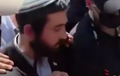 Thumbnail preview image for the video titled: Under heavy protection, MK Zvi Sukkot tries to break into a Bedouin school in Tuba-Zangariyye with an angle grinder