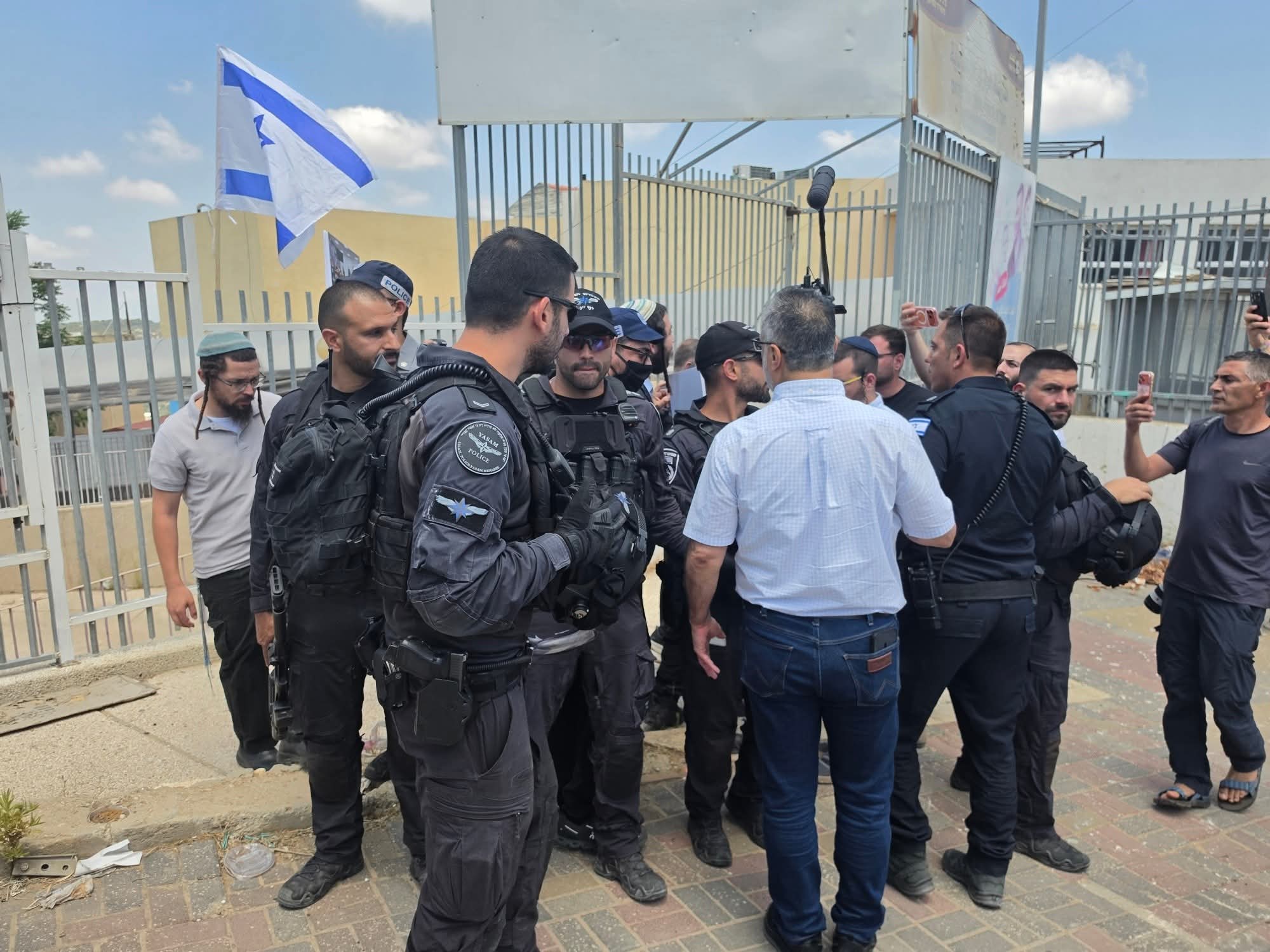 Thumbnail preview image for the video titled: After failing to storm the school, Zvi Sukkot hung an Israel flag on the fence of an 'Arab' school in Umm al-Fahm City