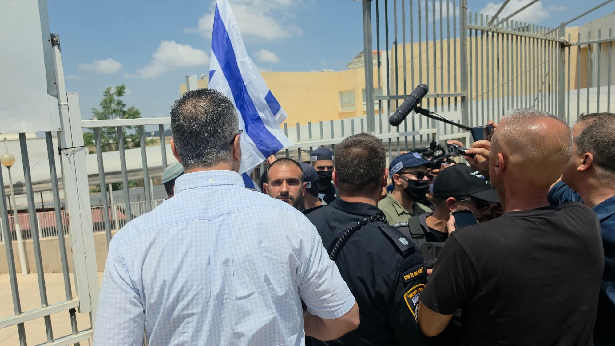 Thumbnail preview image for the video titled: Zvi Sukkot hung an Israel flag on the fence of an 'Arab' school in Umm al-Fahm City