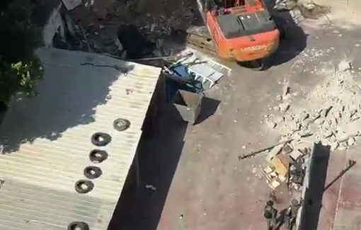 Thumbnail preview image for the video titled: Israeli bulldozers demolished a washing machine as part of the large-scale demolition operation in Qalandia