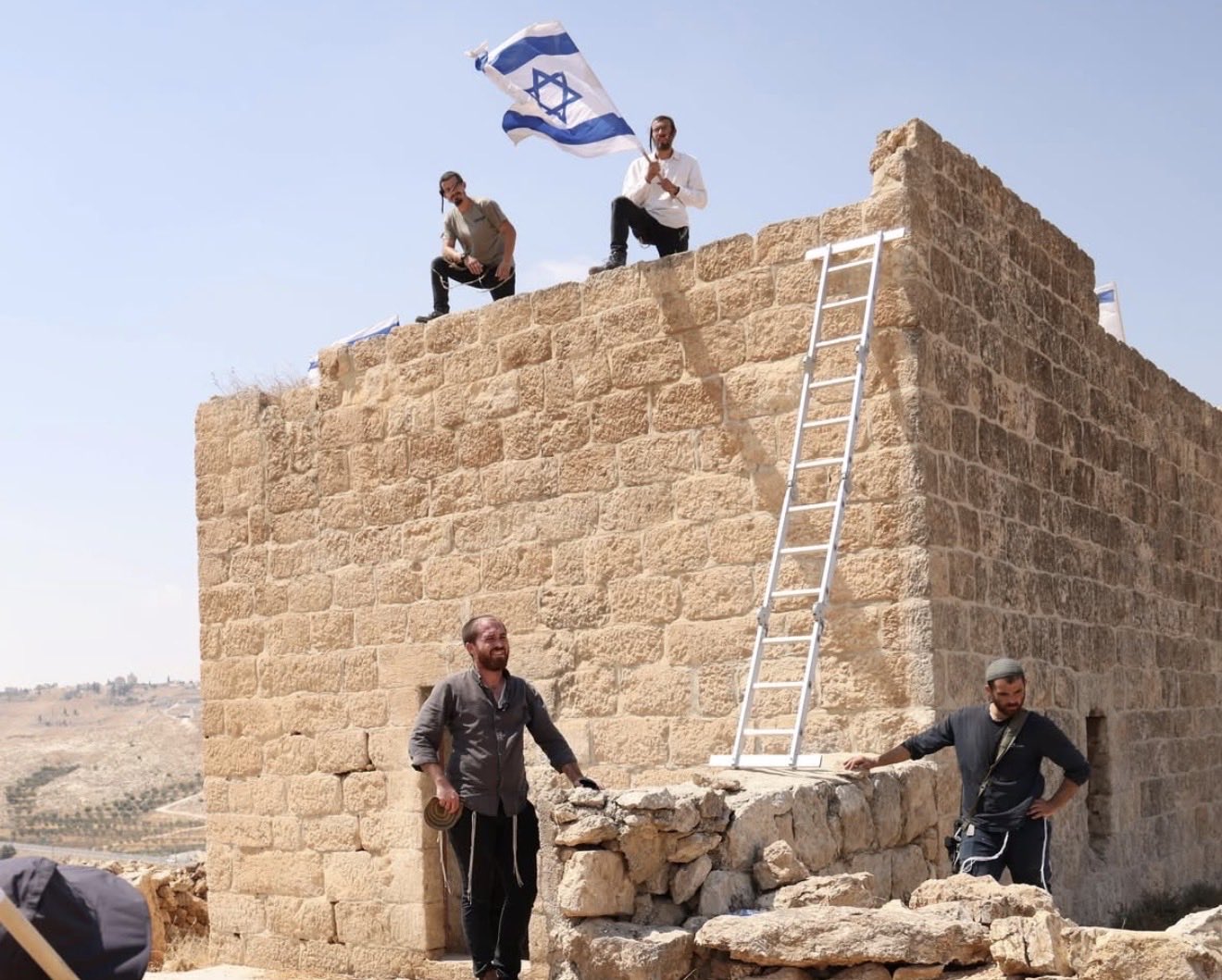 Thumbnail preview image for the video titled: Israeli settler taking over a Palestinian home in Beit Sahour, raising Israeli flags over it