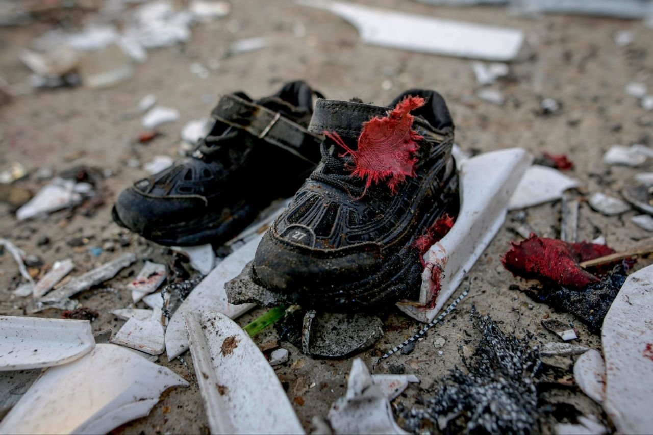 Thumbnail preview image for the video titled: Blood-splattered child's shoes at scene of Israel's massacre of Palestinians at Gaza Port