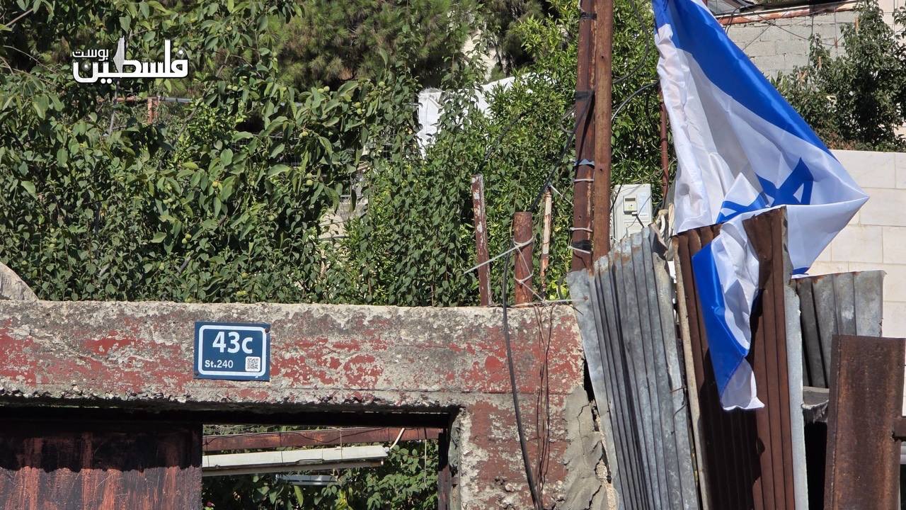 Thumbnail preview image for the video titled: Settlers raise Israeli flags on Palestinian land in Hebron’s Old City after seizing it under the protection of the soldiers