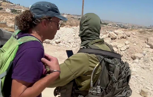 Thumbnail preview image for the video titled: Israeli soldiers watched settlers attacking Israeli activists trying to support Palestinian residents in Jannatah