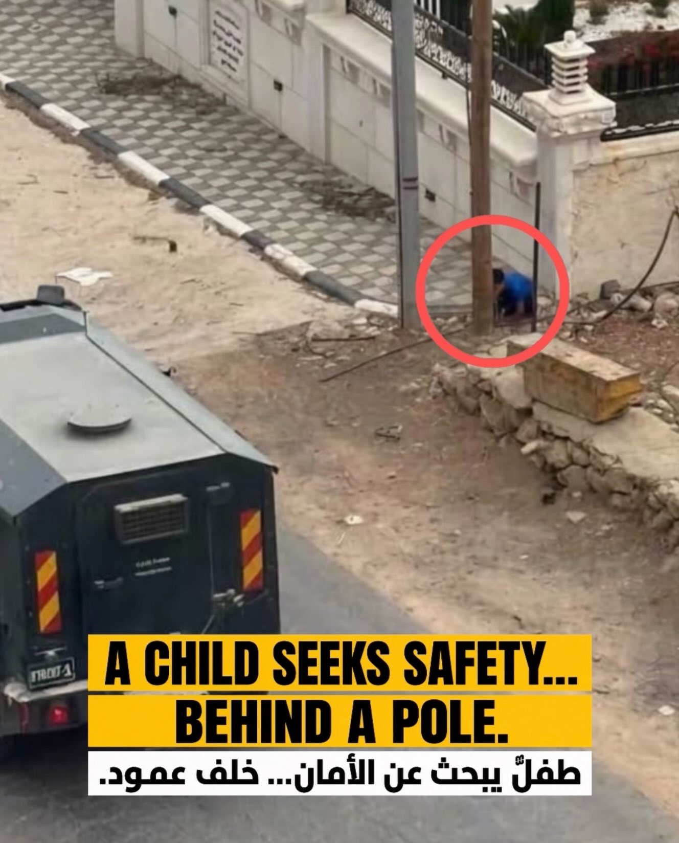 Thumbnail preview image for the video titled: A Palestinian schoolchild quickly hides behind a pole as a military vehicle passes through the village of Al-Mughayyir