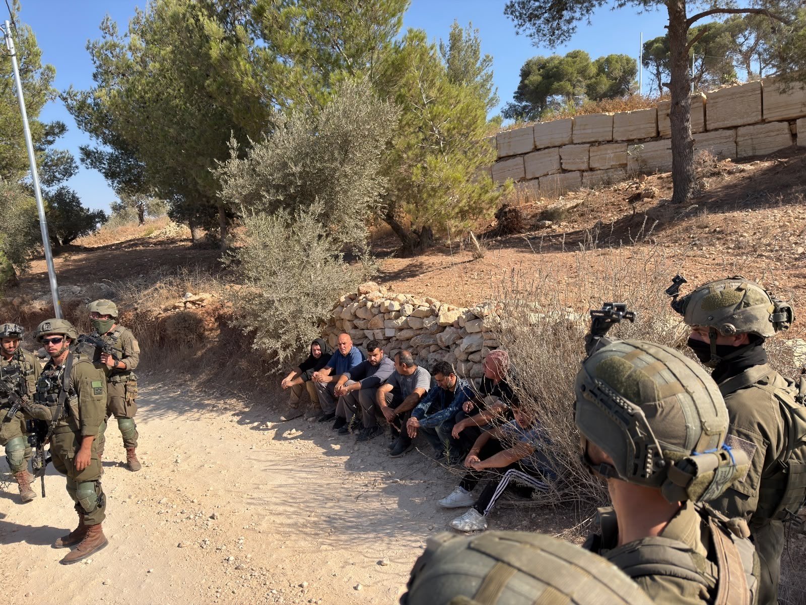 Thumbnail preview image for the video titled: Israeli soldiers detain Palestinian farmers in Jabal Qamaas, near the town of Beita, during the olive harvest