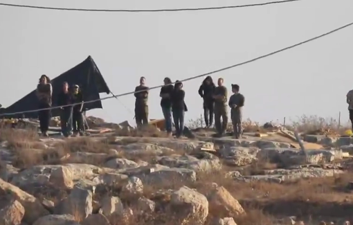 Thumbnail preview image for the video titled: Soldier pray with settlers besieging a Palestinian house in Wadi Rakhim