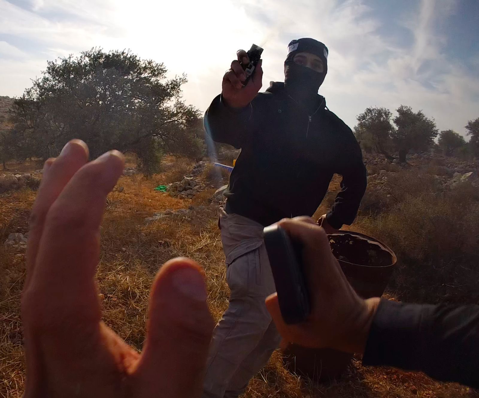 Thumbnail preview image for the video titled: Journalist Fin de Pencier frame of an Israeli settler pepper-spraying him during an olive harvest near Burqa