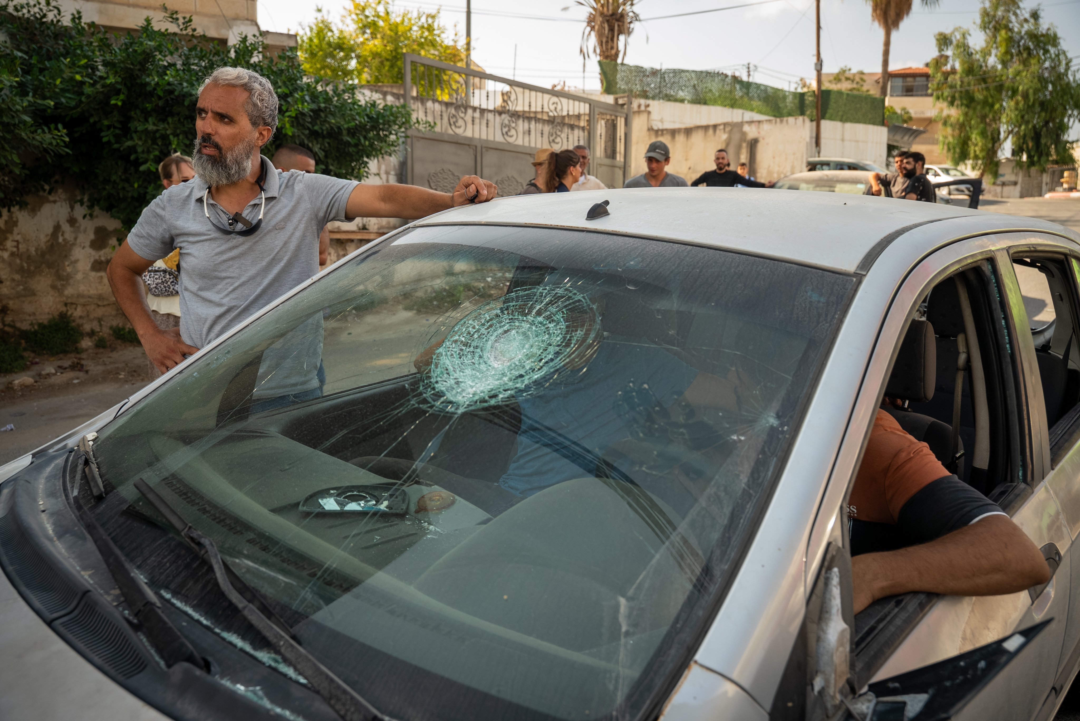 Thumbnail preview image for the video titled: Israeli settlers attacked an olive harvest, smashing a car, beating several people, and stealing part of the harvest.