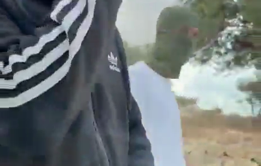 Thumbnail preview image for the video titled: Masked and armed settlers threatening the activists vehicle in the entrance of Taybeh