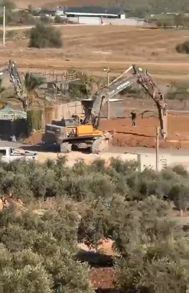 Thumbnail preview image for the video titled: Israeli forces demolishing a wedding hall using Hyundai excavators in Deir Hanna, northern 48 Palestine