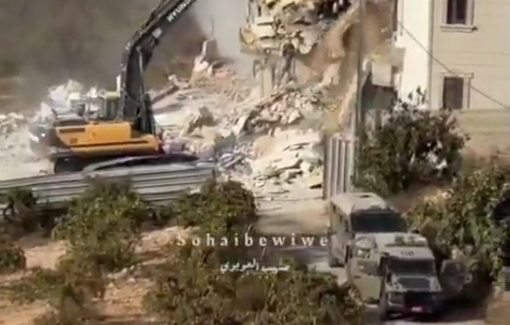 Thumbnail preview image for the video titled: An Israeli excavator demolishes houses as collective punishment for resistance shooting