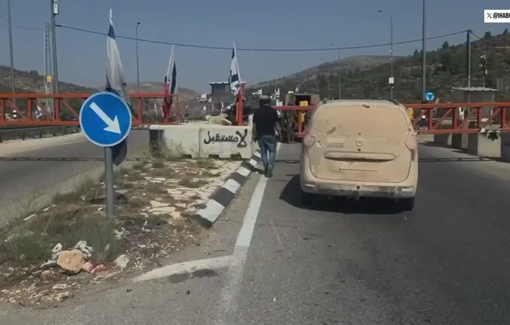 Thumbnail preview image for the video titled: Israeli forces open a West Bank gate for a settler, then shut it, stranding Palestinians
