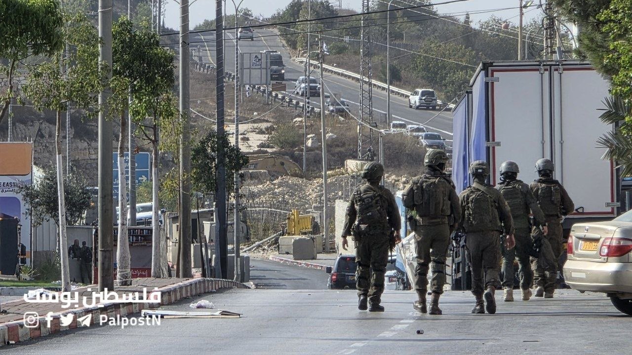 Thumbnail preview image for the video titled: Israeli occupation forces’ vehicles are stationed near the Farsh al-Hawa checkpoint in Hebron, preparing to demolish Palestinian building
