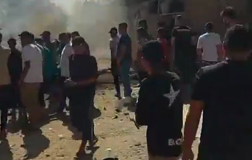Thumbnail preview image for the video titled: Crowd inspects scene massacre scene after Israel killed a police officer in his car in Gaza City