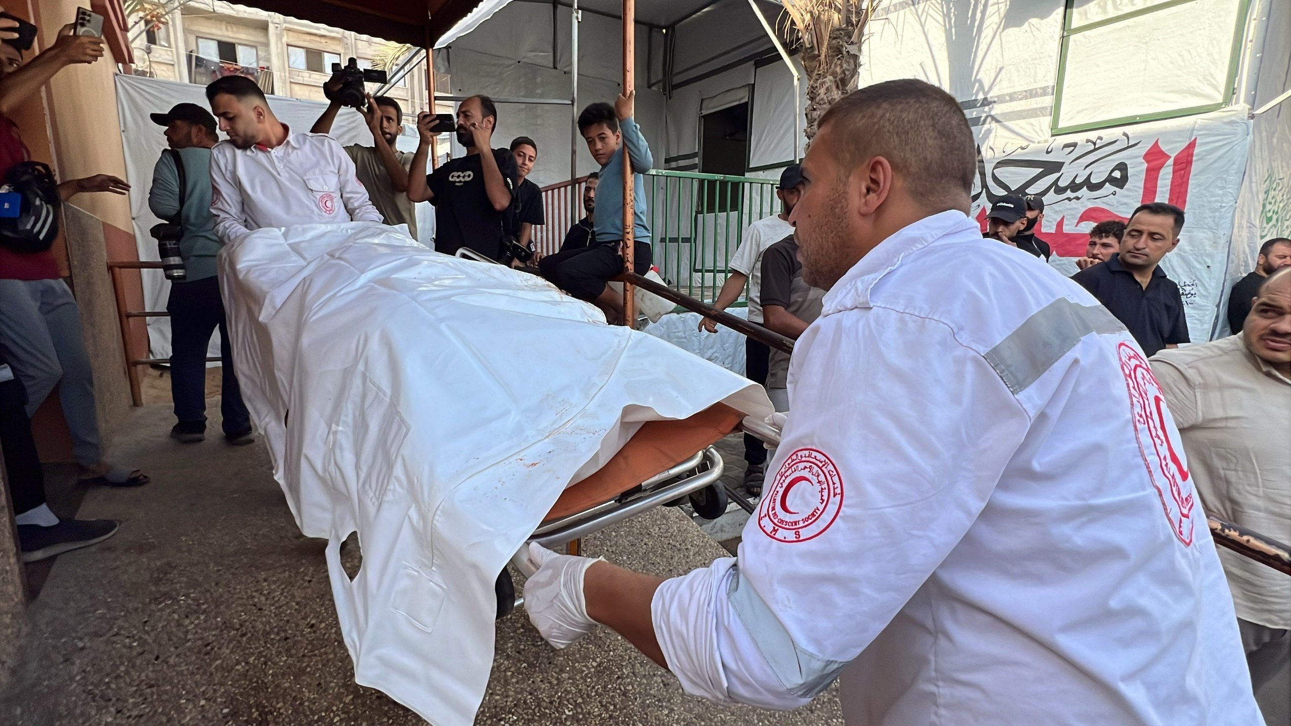 Thumbnail preview image for the video titled: Body of Quran teacher killed by Israeli drone strike brought to hospital