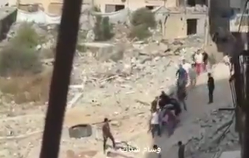 Thumbnail preview image for the video titled: Civilians carry to ambulance bodies Palestinians killed in Israeli strike on their bike