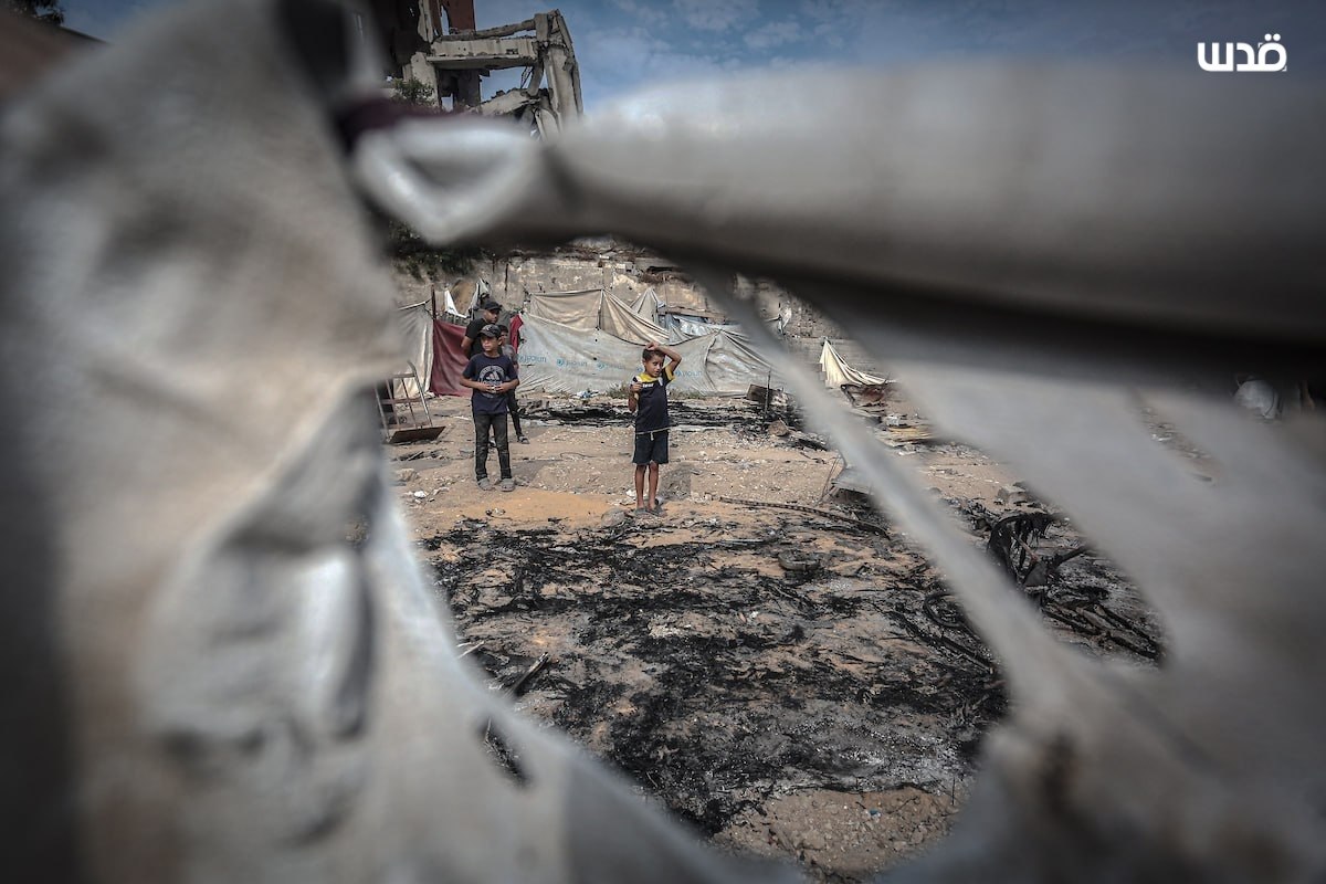 Thumbnail preview image for the video titled: Children inspect the torched remains of their tents burned down by Israeli drones